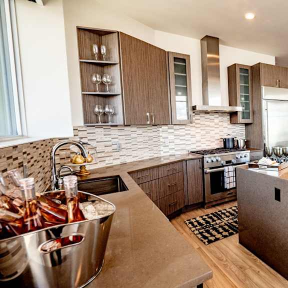 a modern kitchen with a bar area and a dining table set for two.