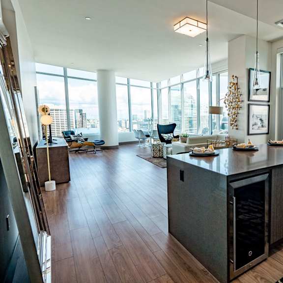 a modern kitchen with a large island and a view of the city.