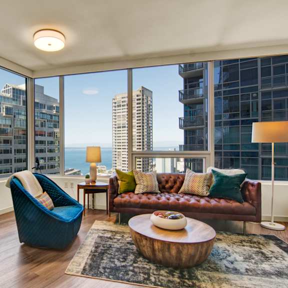 a living room with a view of the cityscape.