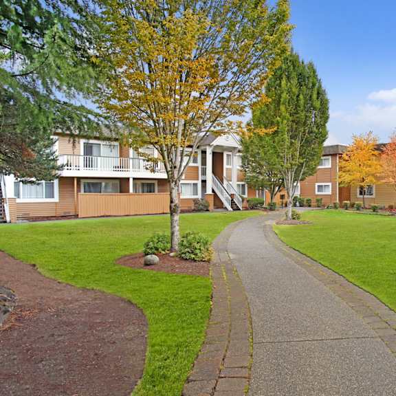 a residential area with apartment buildings and a sidewalk.