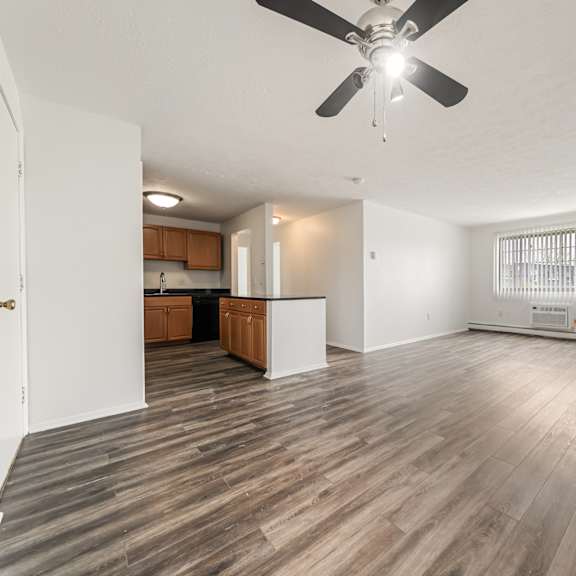 great room with ceiling fan and dining area
