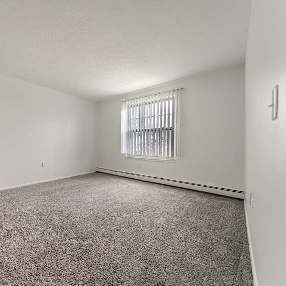 carpeted bedroom with window