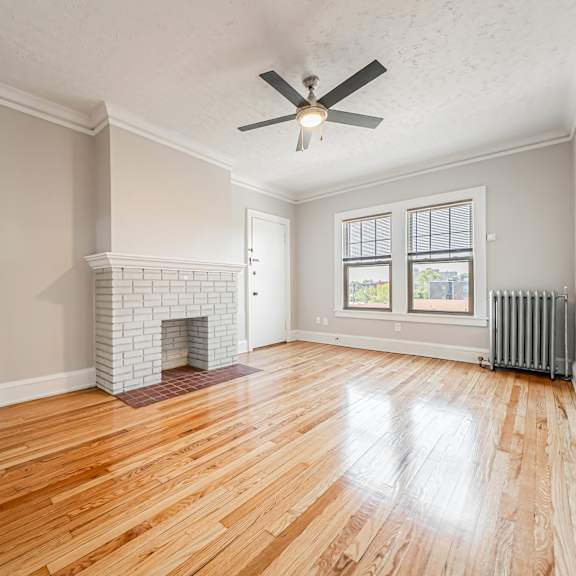 living room with a fireplace and wood flooring at integrity gold coast apartments, cleveland, ohio