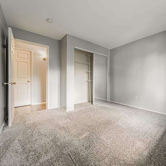 a room with a carpeted floor and two doors. at integrity berea apartments, berea, ohio