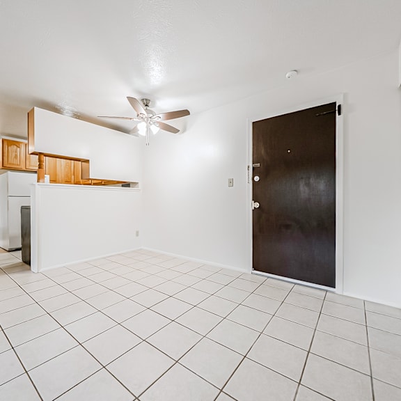 a room with a ceiling fan and a door.