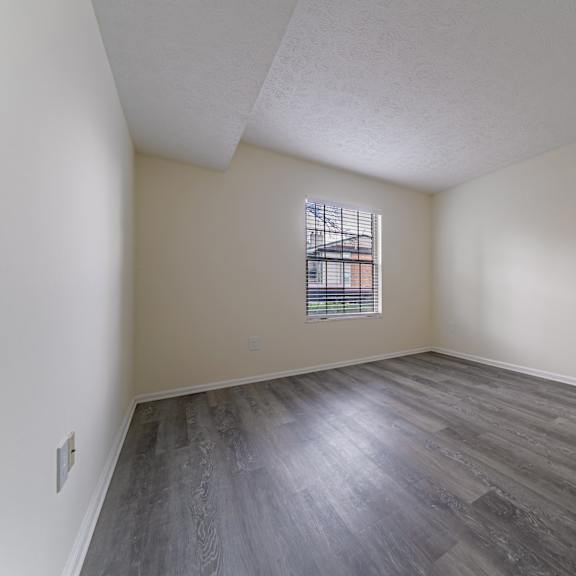 a room with a window and a door at hunt club apartments, ohio