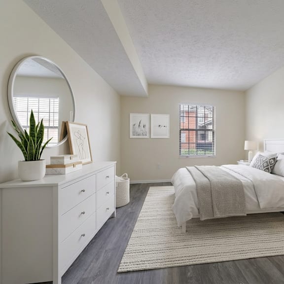 a bedroom with a large bed, a dresser, and a mirror at hunt club apartments, ohio, 44321
