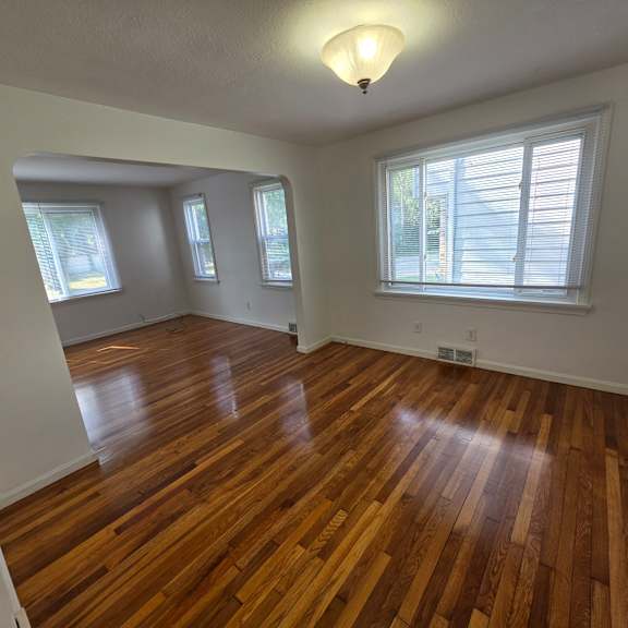 a room with wooden floors and white walls.