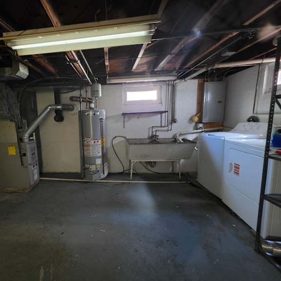 a room with a white appliance and a window.
