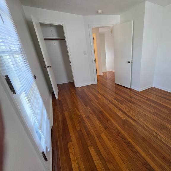 a room with wooden floors and white walls.