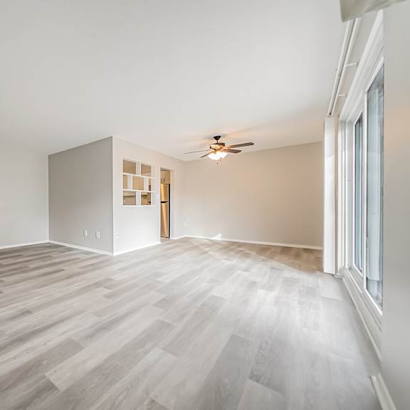 a room with wooden flooring and a ceiling fan.