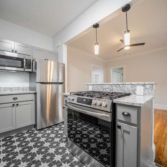 a kitchen with a black and white checkered floor.at integrity cleveland heights apartments,ohio, 44106