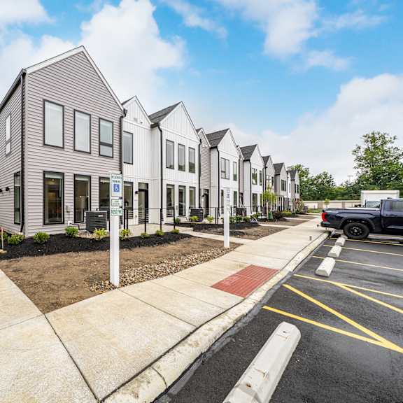 a row of modern houses with a truck parked in the driveway at westwood meadows, westlake, oh, 44145