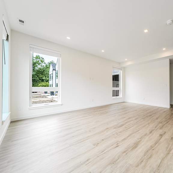 a spacious room with wooden flooring and white walls at westwood meadows, westlake, oh, 44145