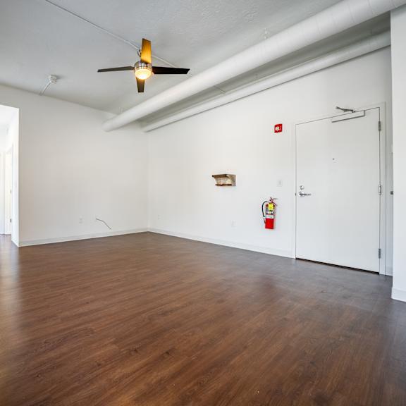 a room with wooden floors and white walls.