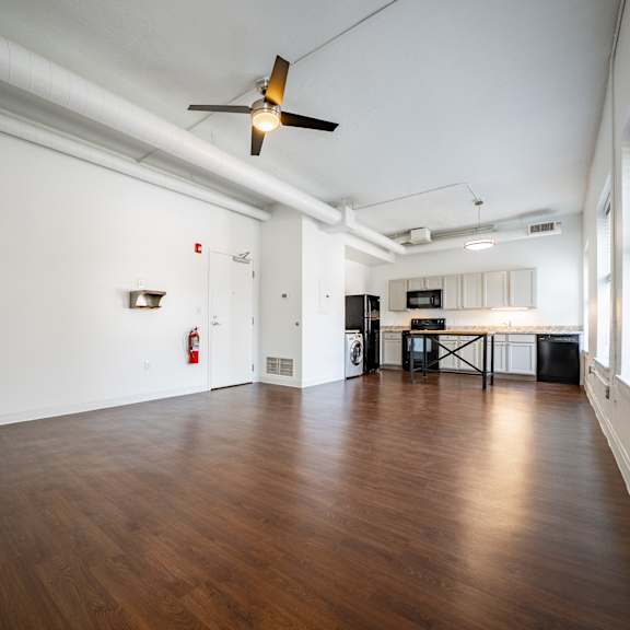 a room with wooden floors and a ceiling fan.