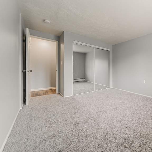 a room with a carpeted floor and a doorway leading to another room. at integrity berea apartments, ohio