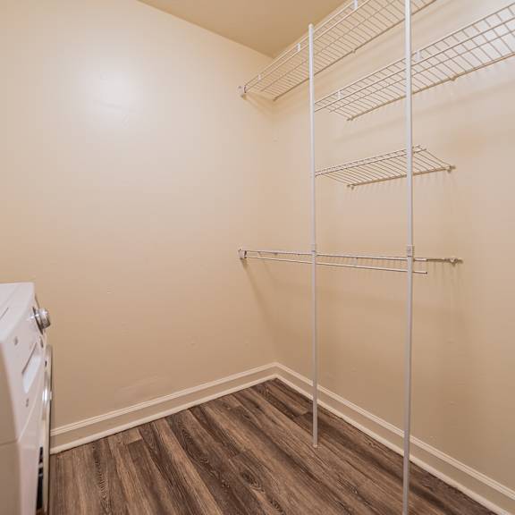 a laundry room with a washer and dryer and a shelf. at integrity berea apartments, berea, ohio