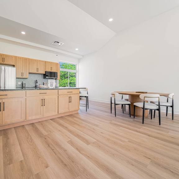 a kitchen with wooden floors and cabinets.