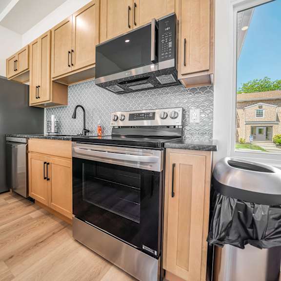 a kitchen with wooden cabinets and stainless steel appliances.
