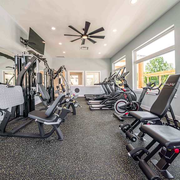 a spacious home gym with a variety of exercise equipment.