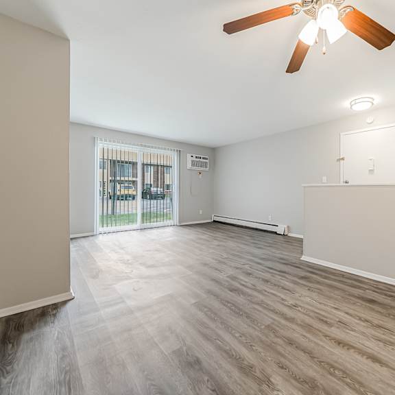 a room with a ceiling fan and wooden flooring at integrity chardon apartments, chardon