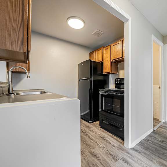 a kitchen with a sink, refrigerator, and cabinets at integrity chardon apartments, chardon, oh,  44024