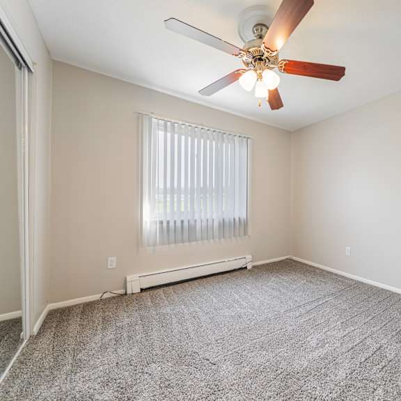 bedroom with a ceiling fan at integrity chardon apartments,ohio