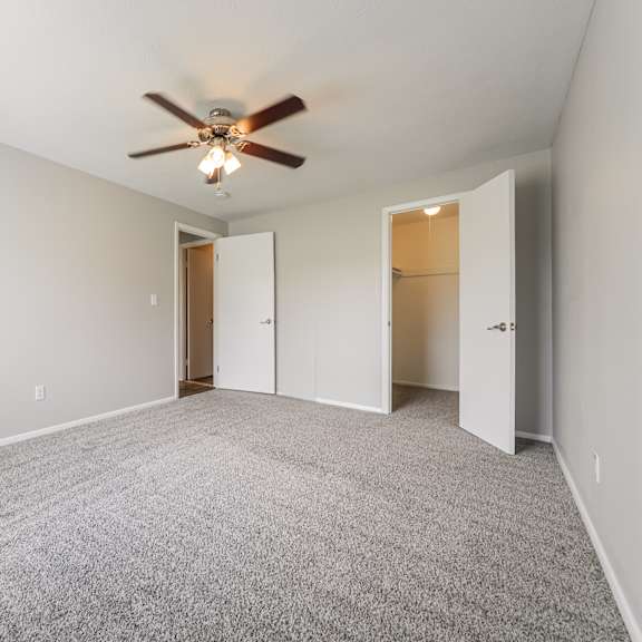 bedroom with a ceiling fan and carpeted floor at integrity chardon apartments, chardon, 44024