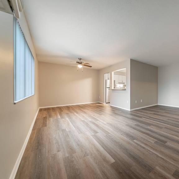 a room with wooden flooring and a ceiling fan.