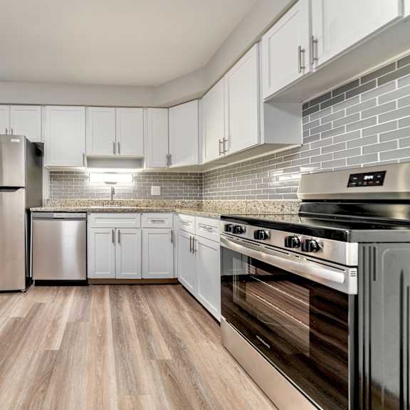 a kitchen with a stainless steel refrigerator, dishwasher, and oven.
