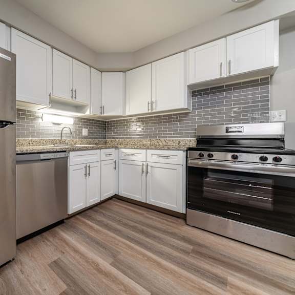 a modern kitchen with a stainless steel refrigerator and oven.