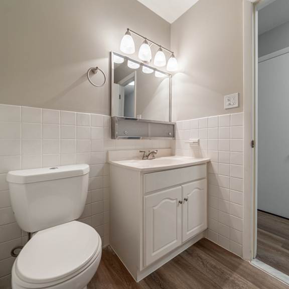 a white toilet sits next to a sink in a bathroom.