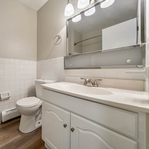a white toilet sits next to a white sink in a bathroom.