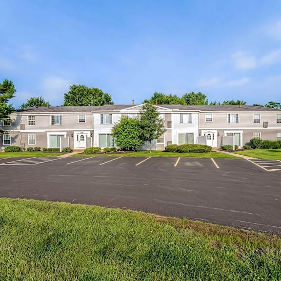 a large building with a parking lot in front of it.