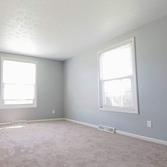 a room with two windows and carpeted floor. at integrity berea apartments, berea, oh, 44017