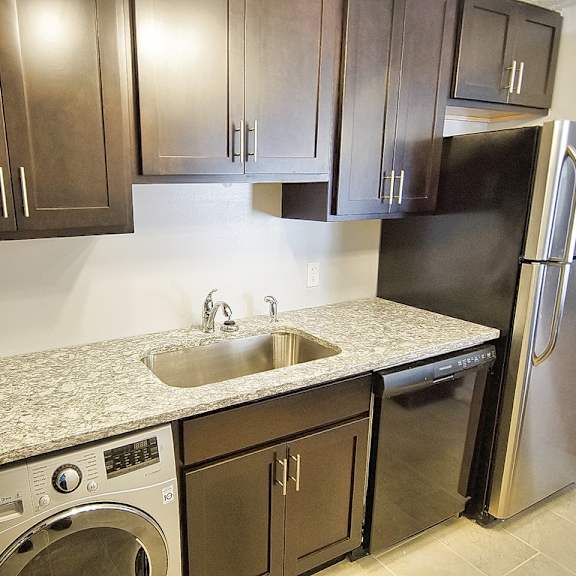 a kitchen with a black refrigerator and a sink. at integrity berea apartments, berea, 44017