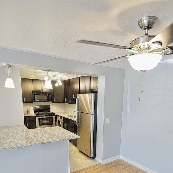 a kitchen with a refrigerator, microwave, and oven. at integrity berea apartments, ohio