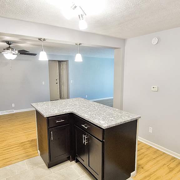 a kitchen with black cabinets and a wooden floor. at integrity berea apartments, ohio, 44017