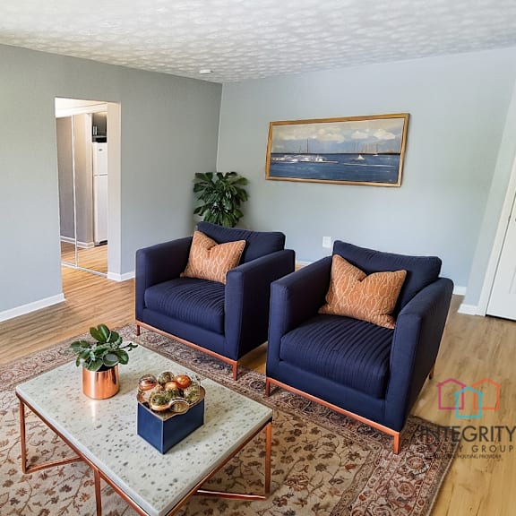 a living room with a blue couch and a coffee table. at integrity berea apartments, berea, ohio