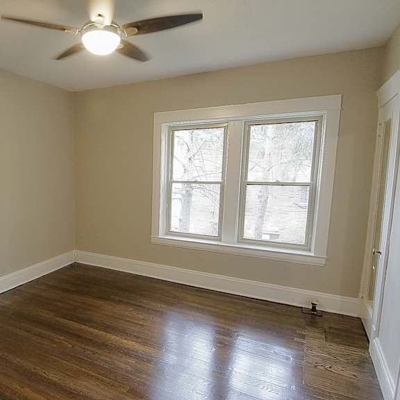 bedroom with hardwood floors and modern ceiling fan at integrity gold coast apartments, apartments, cleveland, oh