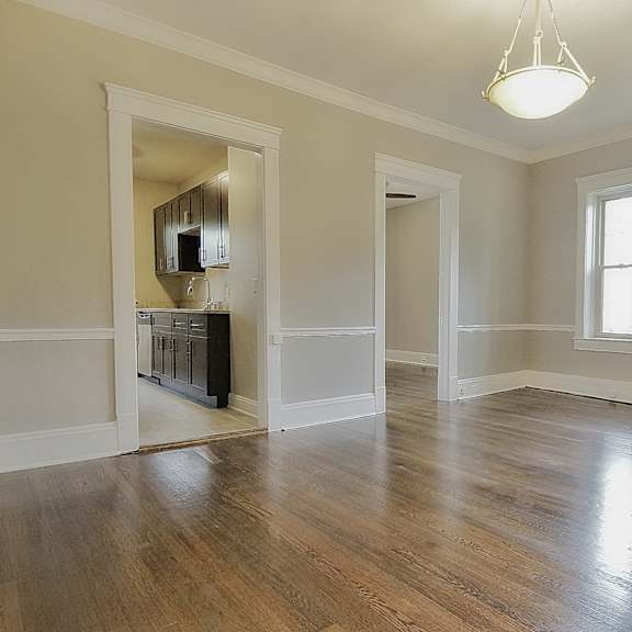 dining room with hardwood floors and a large window. at integrity gold coast apartments, cleveland, 44102