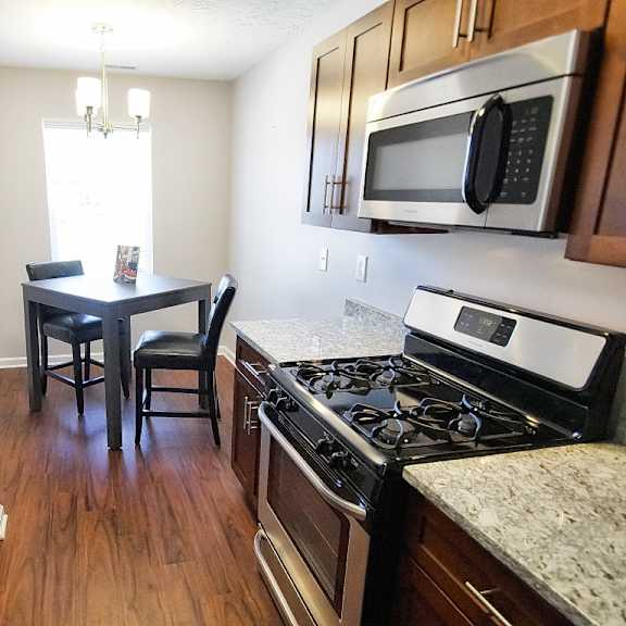 townhome dining and kitchen area featuring dark cherry wood.
