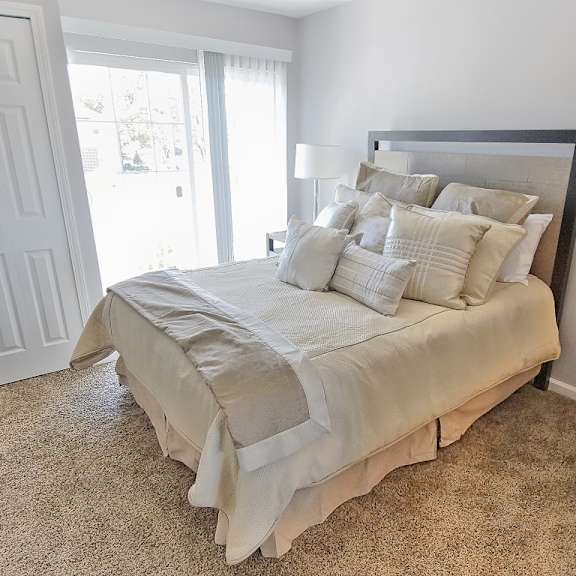 townhome bedroom with large closet and patio access.