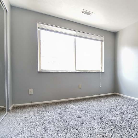 a room with a carpeted floor and a window. at integrity berea apartments, berea, 44017