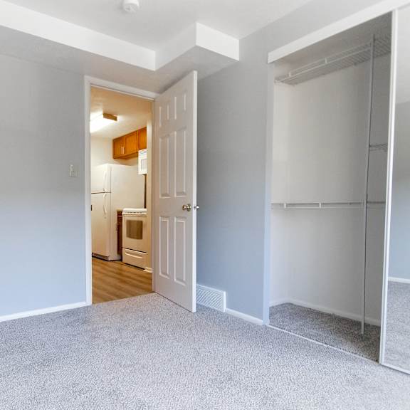 a room with a white door and a grey carpet. at integrity berea apartments, berea, ohio