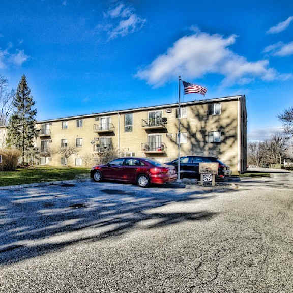 westwood apartments.  parking area in front of the clubhouse / office with a building in the background