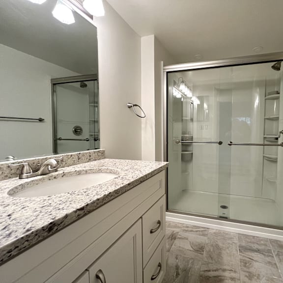 updated bathroom with glass shower at atrium in the village, beachwood ohio
