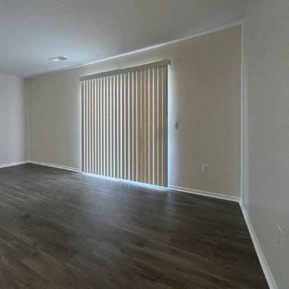 an empty living room with a sliding door