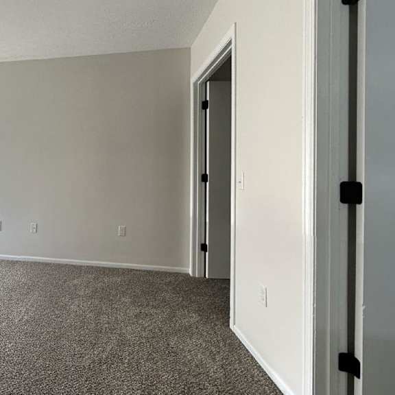 an empty room with a window and a door